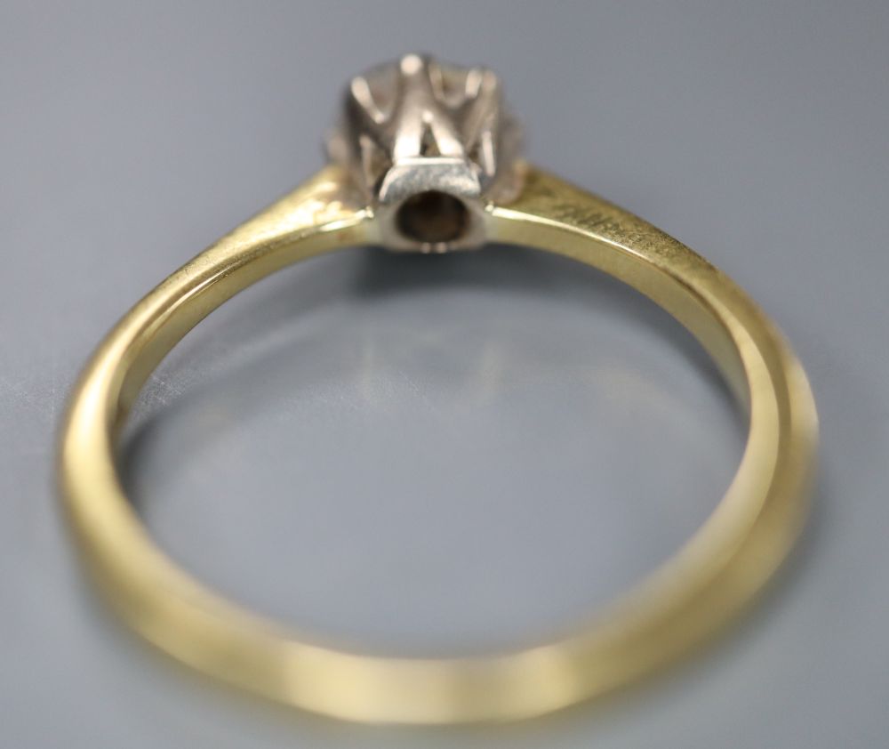 A modern 18ct gold and solitaire diamond ring, size M, gross 2.9 grams,